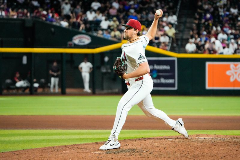 Jun 28, 2025; Phoenix, Arizona, USA; Arizona Diamondbacks relief pitcher Kevin Ginkel (37) delivers a pitch against the Miami Marlins in the seventh inning at Chase Field. Mandatory Credit: Arianna Grainey-Imagn Images