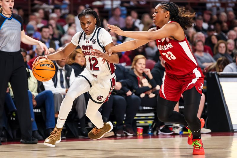 Feb 22, 2024; Columbia, South Carolina, USA; South Carolina Gamecocks guard MiLaysia Fulwiley (12) drives past Alabama Crimson Tide guard Jessica Timmons (23) in the first half at Colonial Life Arena. Mandatory Credit: Jeff Blake-USA TODAY Sports