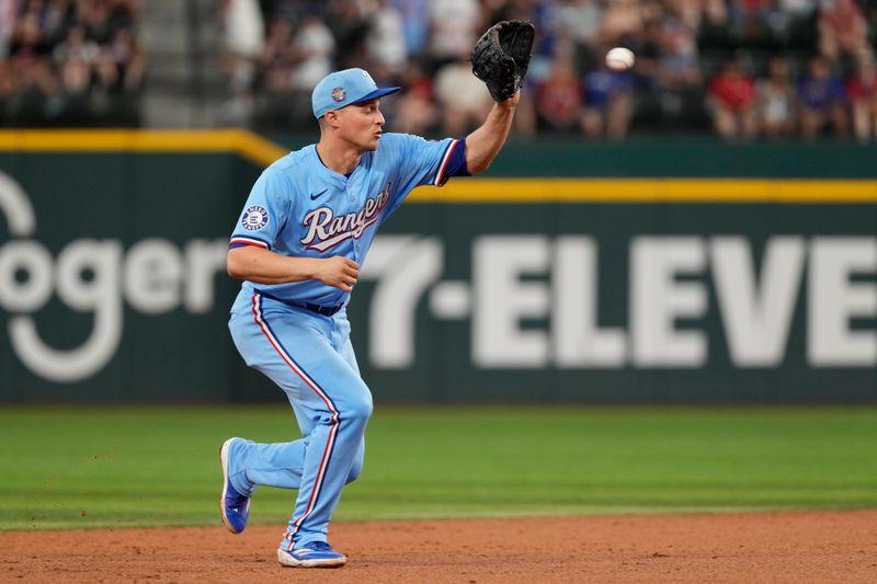 Jun 23, 2024; Arlington, Texas, USA; Texas Rangers shortstop Corey Seager (5) fields the ground out hit by Kansas City Royals center fielder Dairon Blanco (not shown) during the ninth inning at Globe Life Field. Mandatory Credit: Jim Cowsert-USA TODAY Sports