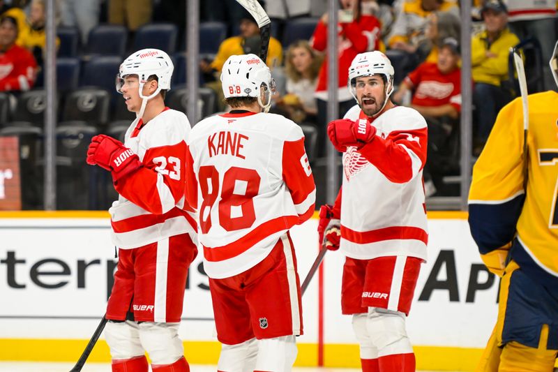 Oct 19, 2024; Nashville, Tennessee, USA; Detroit Red Wings right wing Patrick Kane (88) celebrates the goal of center Dylan Larkin (71) against the Nashville Predators  during the second period at Bridgestone Arena. Mandatory Credit: Steve Roberts-Imagn Images