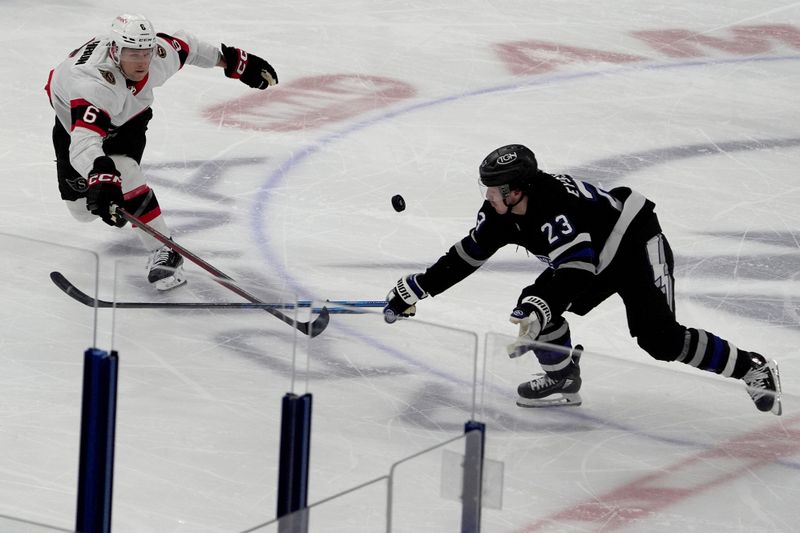 Feb 19, 2024; Tampa, Florida, USA; Ottawa Senators defenseman Jakob Chychrun (6) and Tampa Bay Lightning center Michael Eyssimont (23) battle for the puck during the second period at Amalie Arena. Mandatory Credit: Dave Nelson-USA TODAY Sports