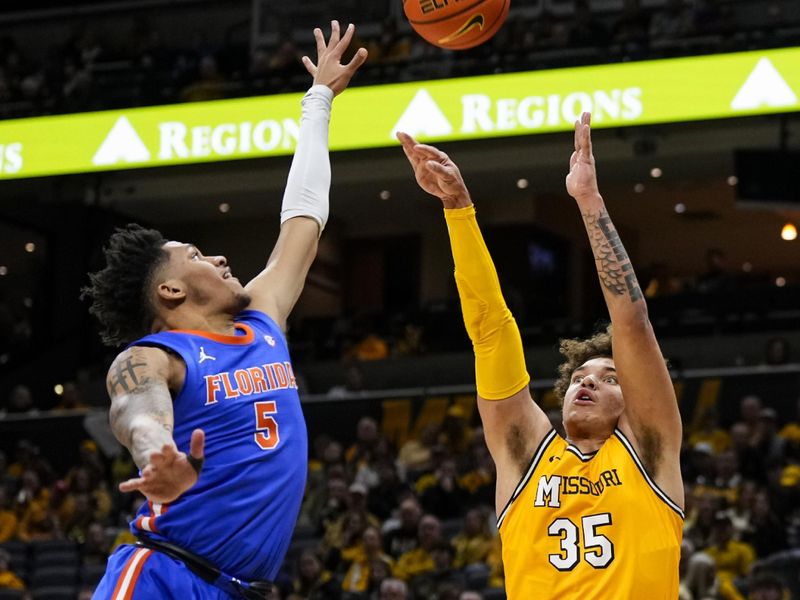 Jan 20, 2024; Columbia, Missouri, USA; Missouri Tigers forward Noah Carter (35) shoots against Florida Gators guard Will Richard (5) during the first half at Mizzou Arena. Mandatory Credit: Jay Biggerstaff-USA TODAY Sports