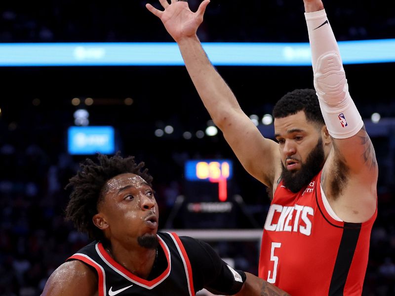 HOUSTON, TEXAS - MARCH 25: Ashton Hagans #19 of the Portland Trail Blazers drives against Fred VanVleet #5 of the Houston Rockets int he first half at Toyota Center on March 25, 2024 in Houston, Texas.  NOTE TO USER: User expressly acknowledges and agrees that, by downloading and or using this photograph, User is consenting to the terms and conditions of the Getty Images License Agreement. (Photo by Tim Warner/Getty Images)