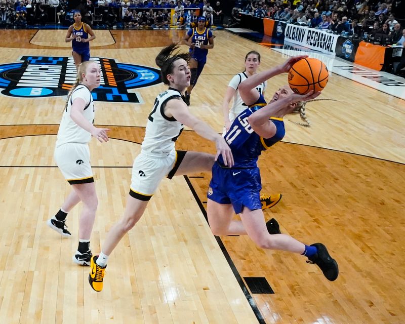 Apr 1, 2024; Albany, NY, USA; LSU Tigers guard Hailey Van Lith (11) shoots a layup against Iowa Hawkeyes guard Caitlin Clark (22) during the first half in the finals of the Albany Regional of the 2024 NCAA Tournament at MVP Arena. Mandatory Credit: Gregory Fisher-USA TODAY Sports