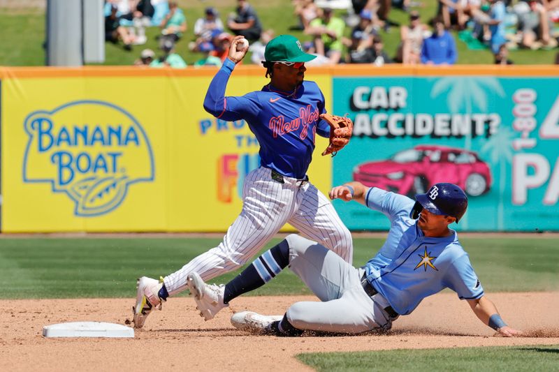 Mar 17, 2025; Port St. Lucie, Florida, USA;  New York Mets shortstop Francisco Lindor (12) tags the base forcing out Tampa Bay Rays outfielder Kameron Misner (26) on a double play during the fifth inning at Clover Park. Mandatory Credit: Reinhold Matay-Imagn Images. 