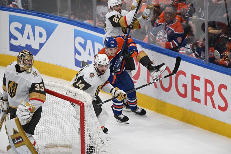 May 12, 2025; Edmonton, Alberta, CAN; Vegas Golden Knights defenseman Nicolas Hague (14) skates against Edmonton Oilers right winger Vasily Podkolzin (92) during the first period in game three of the second round of the 2025 Stanley Cup Playoffs at Rogers Place. Mandatory Credit: Walter Tychnowicz-Imagn Images