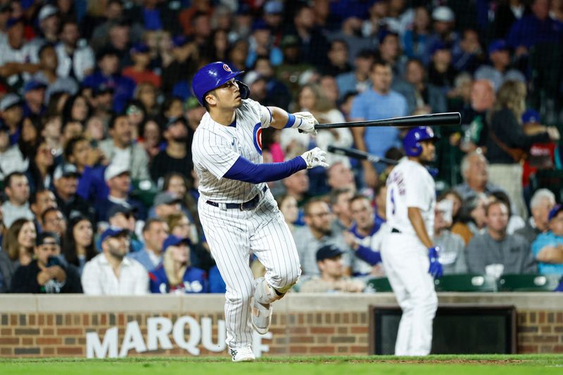 Sep 7, 2023; Chicago, Illinois, USA; Chicago Cubs right fielder Seiya Suzuki (27) triples against the Arizona Diamondbacks during the fifth inning at Wrigley Field. Mandatory Credit: Kamil Krzaczynski-USA TODAY Sports