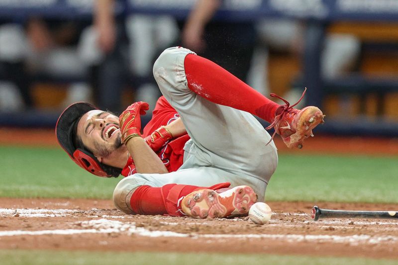 Jul 6, 2023; St. Petersburg, Florida, USA;  Philadelphia Phillies catcher Garrett Stubbs (21) is hit by a pitch against the Tampa Bay Rays in the eleventh inning at Tropicana Field. Mandatory Credit: Nathan Ray Seebeck-USA TODAY Sports