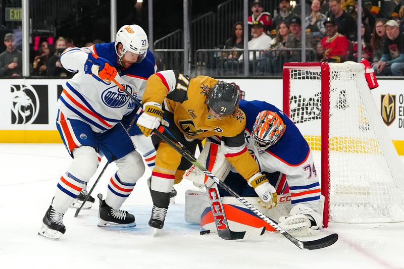 Dec 3, 2024; Las Vegas, Nevada, USA; Edmonton Oilers goaltender Stuart Skinner (74) makes a save as Edmonton Oilers defenseman Brett Kulak (27) looks to clear Vegas Golden Knights center William Karlsson (71) out of the crease during the second period at T-Mobile Arena. Mandatory Credit: Stephen R. Sylvanie-Imagn Images