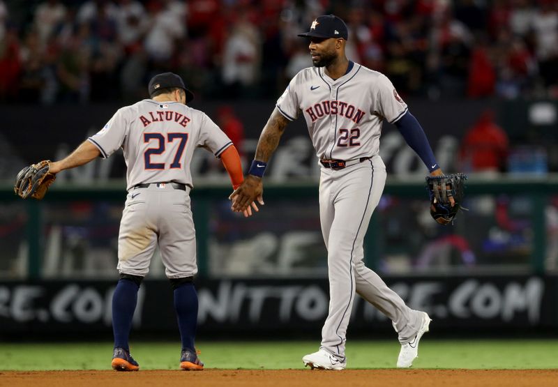 Sep 14, 2024; Anaheim, California, USA; Houston Astros second baseman Jose Altuve (27) and outfielder Jason Heyward (22) celebrate after defeating the Los Angeles Angels at Angel Stadium. Mandatory Credit: Jason Parkhurst-Imagn Images