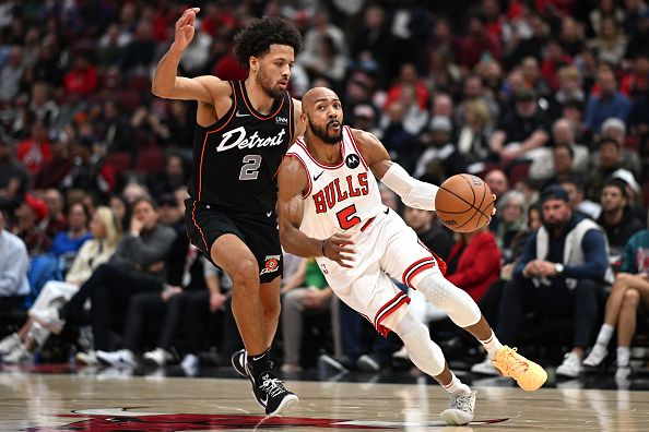 CHICAGO, ILLINOIS - NOVEMBER 12: Jevon Carter #5 of the Chicago Bulls drives with the basketball in the first half against Cade Cunningham #2 of the Detroit Pistons at the United Center on November 12, 2023 in Chicago, Illinois.  NOTE TO USER: User expressly acknowledges and agrees that, by downloading and or using this photograph, User is consenting to the terms and conditions of the Getty Images License Agreement.  (Photo by Quinn Harris/Getty Images)