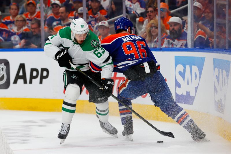May 25, 2025; Edmonton, Alberta, CAN; Dallas Stars right wing Evgenii Dadonov (63) and Edmonton Oilers defenseman Jake Walman (96) battles for control of the puck during the second period in game three of the Western Conference Final of the 2025 Stanley Cup Playoffs at Rogers Place. Mandatory Credit: Perry Nelson-Imagn Images