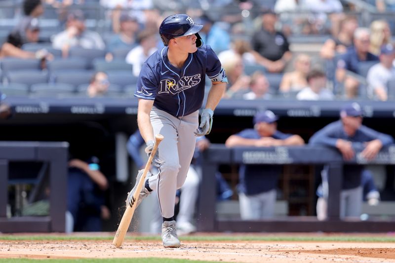 Jul 20, 2024; Bronx, New York, USA; Tampa Bay Rays designated hitter Curtis Mead (25) follows through on an RBI double against the New York Yankees during the third inning at Yankee Stadium. Mandatory Credit: Brad Penner-USA TODAY Sports