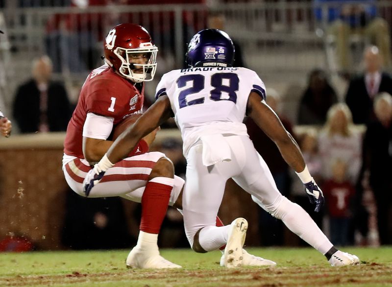 Nov 23, 2019; Norman, OK, USA; TCU Horned Frogs safety Nook Bradford (28) tackles Oklahoma Sooners quarterback Jalen Hurts (1) during the second quarter at Gaylord Family - Oklahoma Memorial Stadium. Mandatory Credit: Kevin Jairaj-USA TODAY Sports