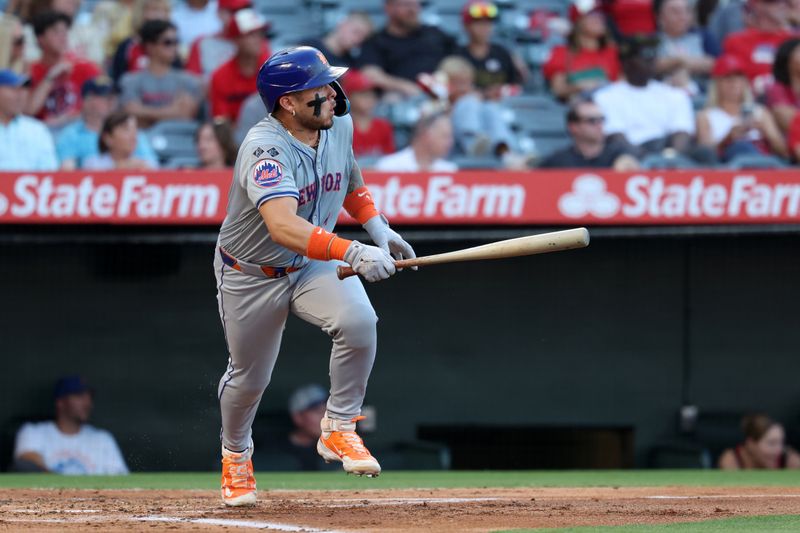 Aug 2, 2024; Anaheim, California, USA;  New York Mets catcher Francisco Alvarez (4) hits an RBI single during the second inning against the Los Angeles Angels at Angel Stadium. Mandatory Credit: Kiyoshi Mio-USA TODAY Sports