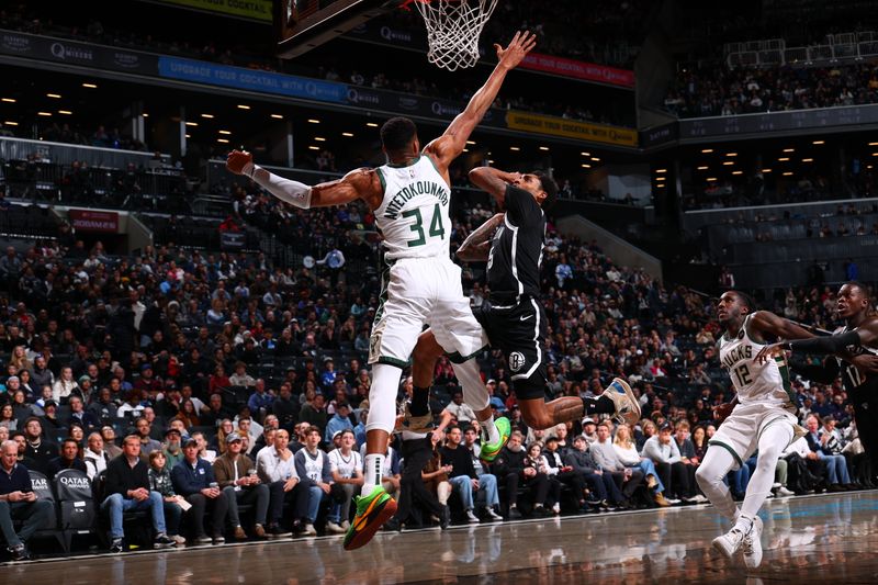 BROOKLYN, NY - DECEMBER 8: Giannis Antetokounmpo #34 of the Milwaukee Bucks defends Keon Johnson #45 of the Brooklyn Nets during the game on December 8, 2024 at Barclays Center in Brooklyn, New York. NOTE TO USER: User expressly acknowledges and agrees that, by downloading and or using this Photograph, user is consenting to the terms and conditions of the Getty Images License Agreement. Mandatory Copyright Notice: Copyright 2024 NBAE (David L. Nemec/NBAE via Getty Images)