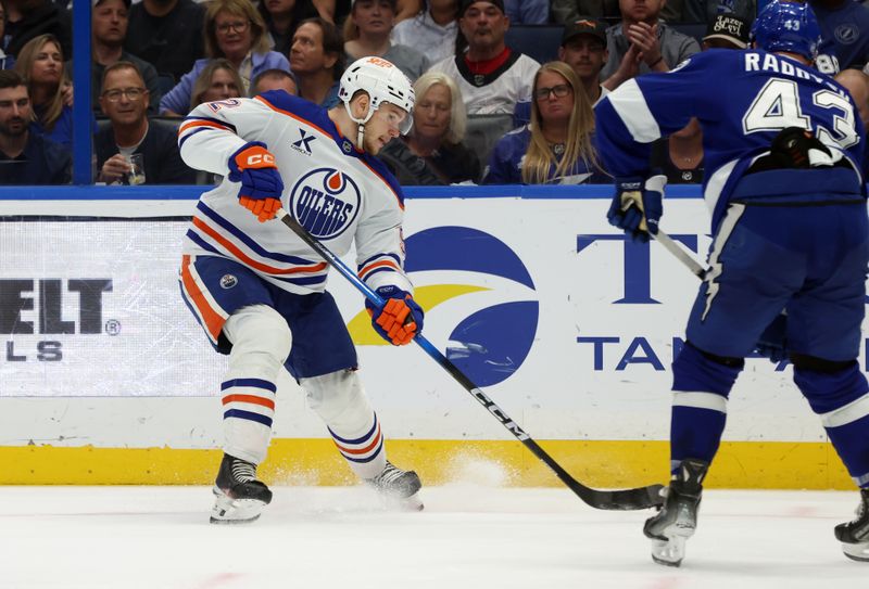 Nov 20, 2025; Tampa, Florida, USA; Edmonton Oilers right wing Vasily Podkolzin (92) passes the puck against the Tampa Bay Lightning during the second period at Benchmark International Arena. Mandatory Credit: Kim Klement Neitzel-Imagn Images