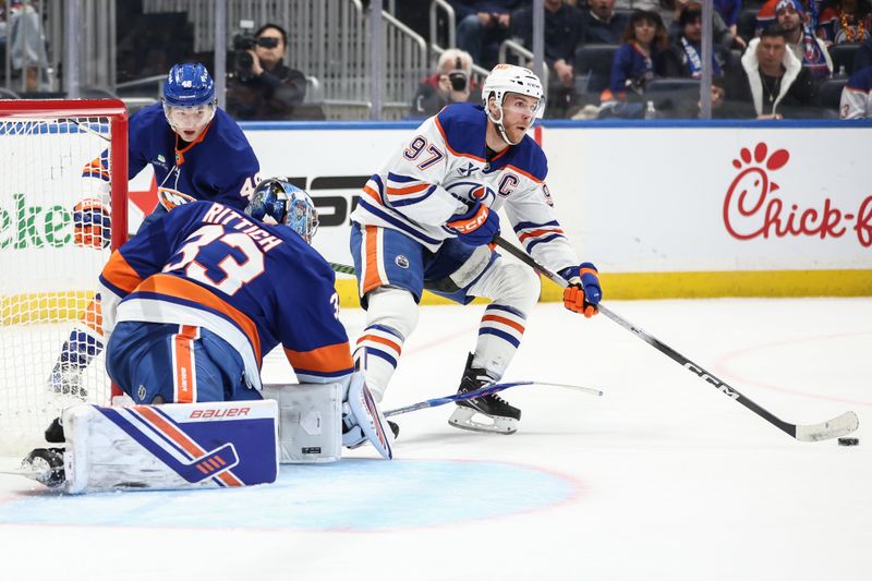Oct 16, 2025; Elmont, New York, USA; New York Islanders goaltender David Rittich (33) defends against a shot on goal attempt by Edmonton Oilers center Connor McDavid (97) in the third period at UBS Arena. Mandatory Credit: Wendell Cruz-Imagn Images