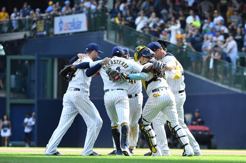 Aug 27, 2023; Milwaukee, Wisconsin, USA; Milwaukee Brewers infielders celebrate a 10-6 win over the San Diego Padres at American Family Field. Mandatory Credit: Michael McLoone-USA TODAY Sports