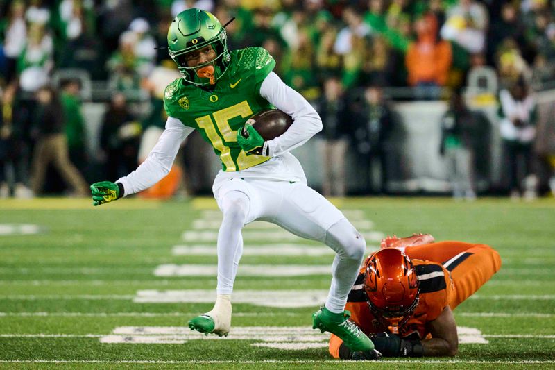 Nov 24, 2023; Eugene, Oregon, USA; Oregon Ducks wide receiver Tez Johnson (15) picks up a first down during the first half as he breaks away from Oregon State Beavers linebacker Easton Mascarenas-Arnold (5) at Autzen Stadium. Mandatory Credit: Troy Wayrynen-USA TODAY Sports