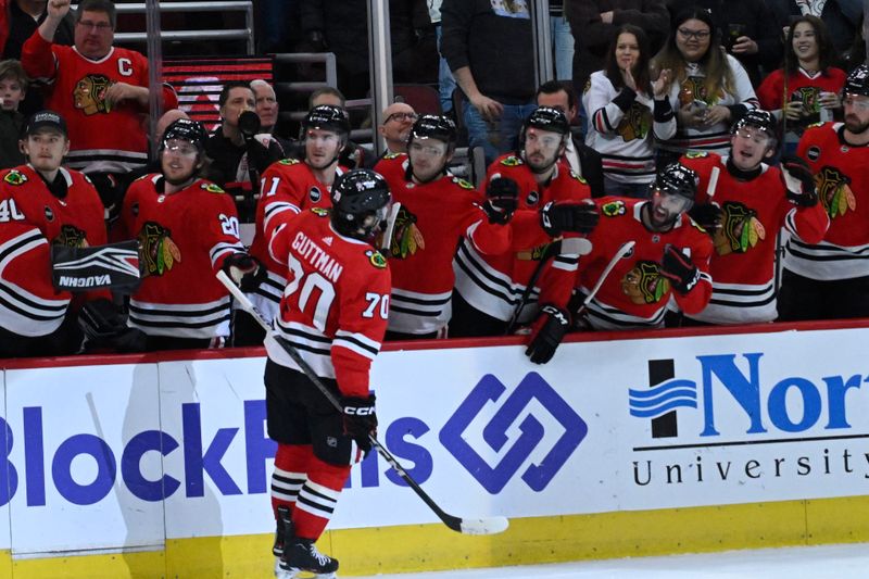 Jan 16, 2024; Chicago, Illinois, USA; Chicago Blackhawks center Cole Guttman (70) celebrates with teammates after scoring a goal against the San Jose Sharks during the first period at United Center. Mandatory Credit: Matt Marton-USA TODAY Sports