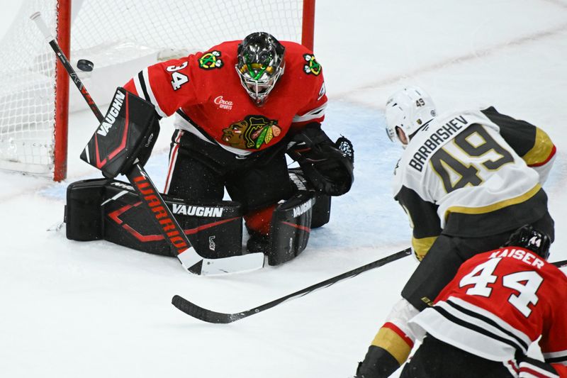 Jan 18, 2025; Chicago, Illinois, USA;  Chicago Blackhawks goaltender Petr Mrazek (34) defends against Vegas Golden Knights center Ivan Barbashev (49) during the second period at United Center. Mandatory Credit: Matt Marton-Imagn Images