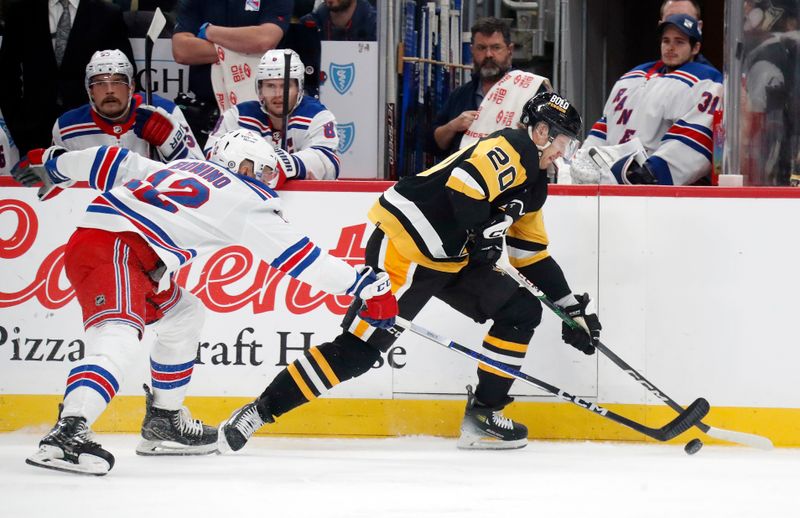 Nov 22, 2023; Pittsburgh, Pennsylvania, USA; Pittsburgh Penguins center Lars Eller (20) moves the puck against New York Rangers center Nick Bonino (12) during the first period at PPG Paints Arena. Mandatory Credit: Charles LeClaire-USA TODAY Sports