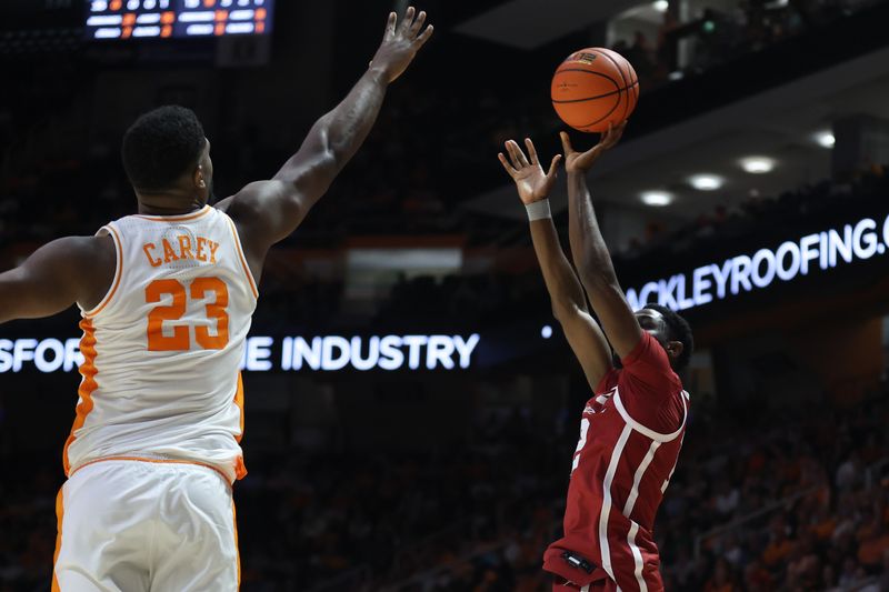 Feb 18, 2026; Knoxville, Tennessee, USA;  Oklahoma Sooners guard Jadon Jones (12) shoots a three pointer against Tennessee Volunteers forward Jaylen Carey (23) during the second half at Thompson-Boling Arena at Food City Center. Mandatory Credit: Randy Sartin-Imagn Images