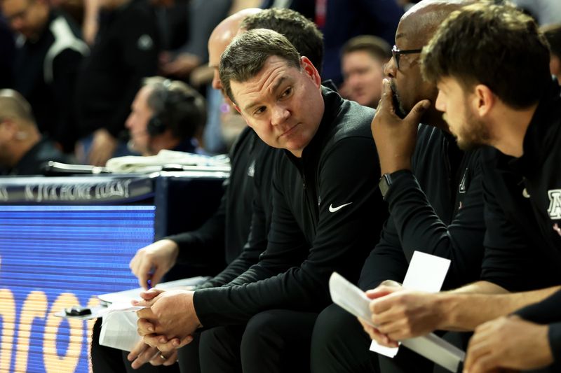 Jan 17, 2024; Tucson, Arizona, USA; Arizona Wildcats head coach Tommy Lloyd on the bench against the USC Trojans during the first half at McKale Center. Mandatory Credit: Zachary BonDurant-USA TODAY Sports