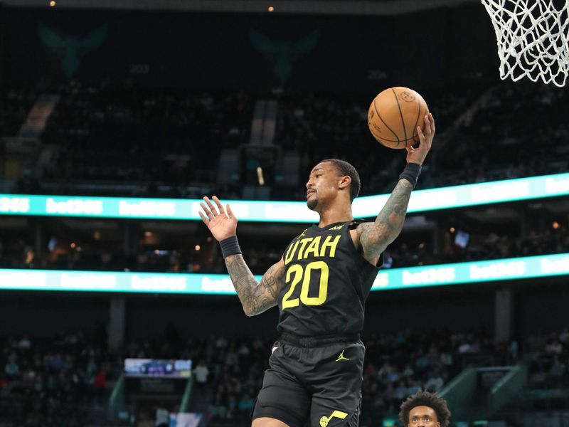 CHARLOTTE, NC - JANUARY 27: John Collins #20 of the Utah Jazz rebounds the ball during the game against the Charlotte Hornets on January 27, 2024 at Spectrum Center in Charlotte, North Carolina. NOTE TO USER: User expressly acknowledges and agrees that, by downloading and or using this photograph, User is consenting to the terms and conditions of the Getty Images License Agreement.  Mandatory Copyright Notice:  Copyright 2024 NBAE (Photo by Brock Williams-Smith/NBAE via Getty Images)