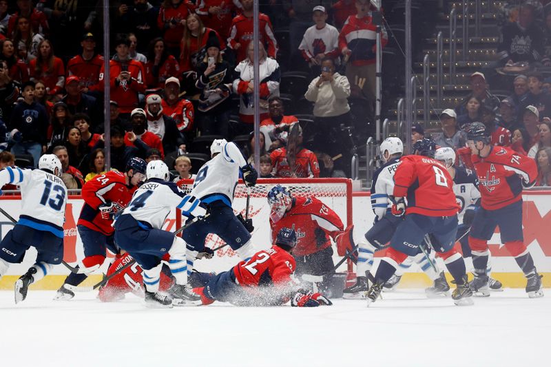 Nov 26, 2025; Washington, District of Columbia, USA; Winnipeg Jets and Washington Capitals players battle for the puck in front of Capitals goaltender Charlie Lindgren (79) in the final seconds during the third period at Capital One Arena. Mandatory Credit: Geoff Burke-Imagn Images