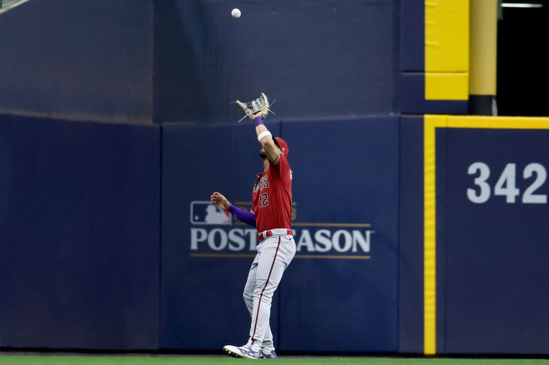 Oct 4, 2023; Milwaukee, Wisconsin, USA; Arizona Diamondbacks left fielder Lourdes Gurriel Jr. (12) makes a catch against Milwaukee Brewers left fielder Christian Yelich (not pictured) in the fifth inning during game two of the Wildcard series for the 2023 MLB playoffs at American Family Field. Mandatory Credit: Kamil Krzaczynski-USA TODAY Sports