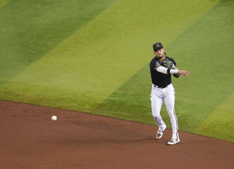 Sep 3, 2023; Phoenix, Arizona, USA; Arizona Diamondbacks second baseman Ketel Marte (4) throws to first base against the Baltimore Orioles during the fifth inning at Chase Field. Mandatory Credit: Joe Camporeale-USA TODAY Sports