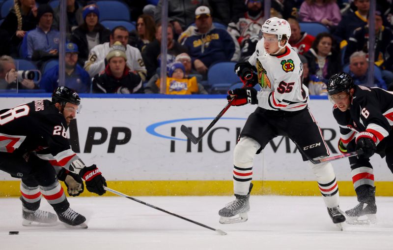 Jan 18, 2024; Buffalo, New York, USA;  \b38\ tries to block a shot by Chicago Blackhawks defenseman Kevin Korchinski (55) during the second period at KeyBank Center. Mandatory Credit: Timothy T. Ludwig-USA TODAY Sports