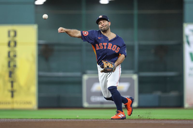 Apr 2, 2024; Houston, Texas, USA; Houston Astros second baseman Jose Altuve (27) throws out a runner during the first inning against the Toronto Blue Jays at Minute Maid Park. Mandatory Credit: Troy Taormina-USA TODAY Sports