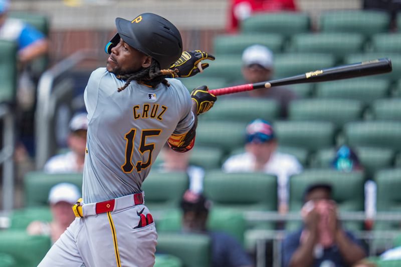 Jun 30, 2024; Cumberland, Georgia, USA; Pittsburgh Pirates shortstop Oneil Cruz (15) gets a base hit against the Atlanta Braves during the seventh inning at Truist Park. Mandatory Credit: Dale Zanine-USA TODAY Sports