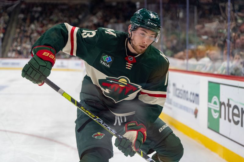 Jan 7, 2025; Saint Paul, Minnesota, USA; Minnesota Wild center Yakov Trenin (13) plays the puck in the corner against the St. Louis Blues in the first period at Xcel Energy Center. Mandatory Credit: Matt Blewett-Imagn Images