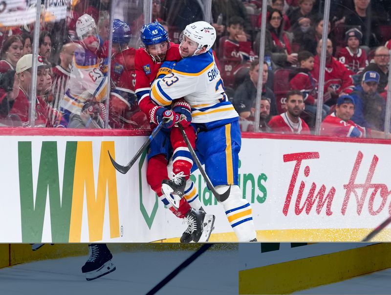 Jan 22, 2026; Montreal, Quebec, CAN; Buffalo Sabres defenseman Mattias Samuelsson (23) checks Montreal Canadiens defenseman Alexandre Carrier (45) during the third period at the Bell Centre. Mandatory Credit: Eric Bolte-Imagn Images