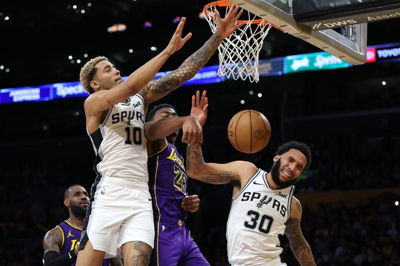 LOS ANGELES, CALIFORNIA - FEBRUARY 23: Jeremy Sochan #10 and Julian Champagnie #30 of the San Antonio Spurs battle Rui Hachimura #28 of the Los Angeles Lakers for a rebound during the second half of a game at Crypto.com Arena on February 23, 2024 in Los Angeles, California. (Photo by Sean M. Haffey/Getty Images)