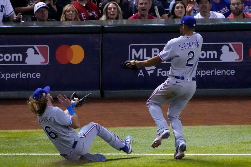 Oct 31, 2023; Phoenix, Arizona, USA; Texas Rangers left fielder Travis Jankowski (16) makes a diving catch in front of second baseman Marcus Semien (2) against the Arizona Diamondbacks during the seventh inning in game four of the 2023 World Series at Chase Field. Mandatory Credit: Rick Scuteri-USA TODAY Sports