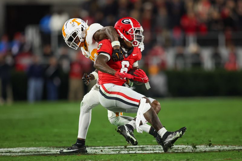 Nov 16, 2024; Athens, Georgia, USA; Georgia Bulldogs wide receiver Dominic Lovett (6) is tackled by Tennessee Volunteers defensive back Boo Carter (23) in the third quarter at Sanford Stadium. Mandatory Credit: Brett Davis-Imagn Images
