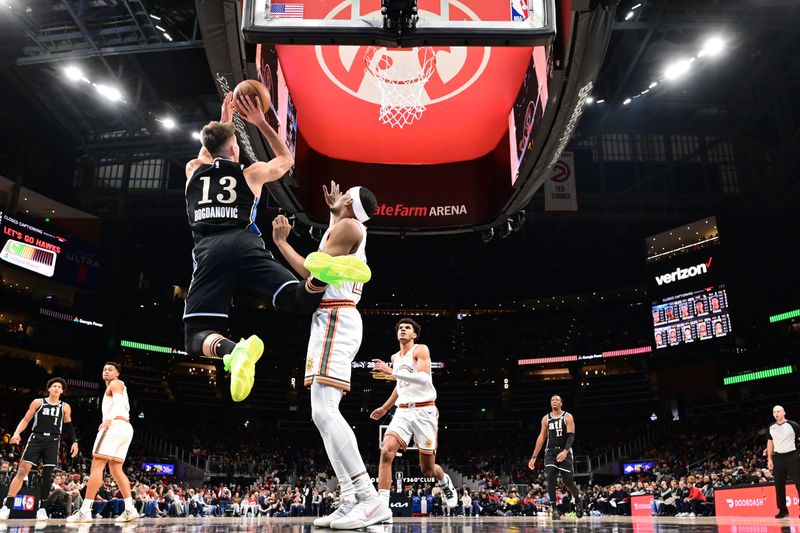 ATLANTA, GA - JANUARY 15: Bogdan Bogdanovic #13 of the Atlanta Hawks looks to pass the ball during the game against the San Antonio Spurs on January 15, 2024 at State Farm Arena in Atlanta, Georgia.  NOTE TO USER: User expressly acknowledges and agrees that, by downloading and/or using this Photograph, user is consenting to the terms and conditions of the Getty Images License Agreement. Mandatory Copyright Notice: Copyright 2024 NBAE (Photo by Adam Hagy/NBAE via Getty Images)