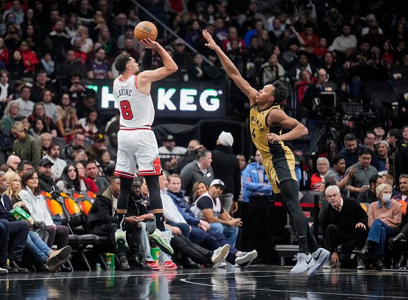 TORONTO, ON - NOVEMBER 24: Zach LaVine #8 of the Chicago Bulls shoots against Scottie Barnes #4 of the Toronto Raptors during the first half of the NBA In-Season Tournament game at the Scotiabank Arena on November 24, 2023 in Toronto, Ontario, Canada. NOTE TO USER: User expressly acknowledges and agrees that, by downloading and/or using this Photograph, user is consenting to the terms and conditions of the Getty Images License Agreement. (Photo by Mark Blinch/Getty Images)