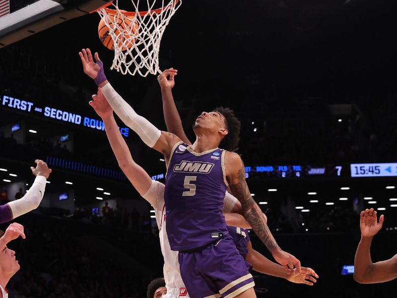 Mar 22, 2024; Brooklyn, NY, USA; James Madison Dukes guard Terrence Edwards Jr. (5) shoots the ball against the Wisconsin Badgers in the first round of the 2024 NCAA Tournament at the Barclays Center. Mandatory Credit: Brad Penner-USA TODAY Sports