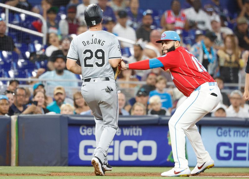 Jul 6, 2024; Miami, Florida, USA;  Miami Marlins third baseman Emmanuel Rivera (15) tags out Chicago White Sox shortstop Paul DeJong (29) after getting caught in a run down during the second inning at loanDepot Park. Mandatory Credit: Rhona Wise-USA TODAY Sports