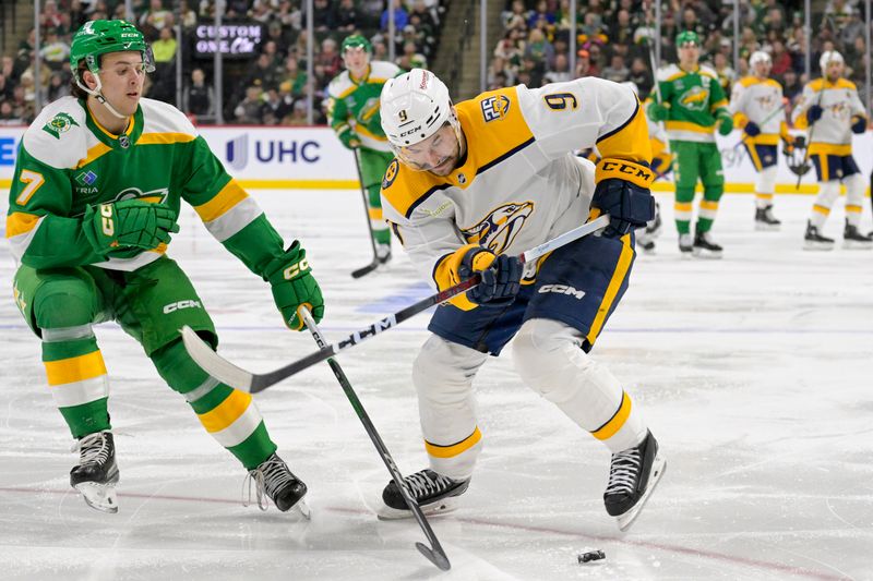 Mar 10, 2024; Saint Paul, Minnesota, USA;  Minnesota Wild defenseman Brock Faber (7) poke-checks the puck away from Nashville Predators forward Filip Forsberg (9) during the third period at Xcel Energy Center. Mandatory Credit: Nick Wosika-USA TODAY Sports

