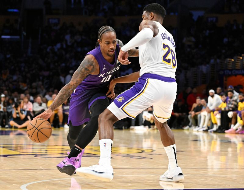LOS ANGELES, CALIFORNIA - OCTOBER 26: Rui Hachimura #28 of the Los Angeles Lakers guards DeMar DeRozan #10 of the Sacramento Kings in the first half at Crypto.com Arena on October 26, 2024 in Los Angeles, California. NOTE TO USER: User expressly acknowledges and agrees that, by downloading and or using this photograph, User is consenting to the terms and conditions of the Getty Images License Agreement. (Photo by John McCoy/Getty Images)
