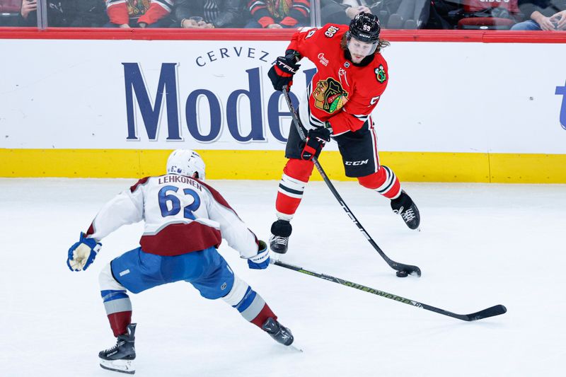 Nov 23, 2025; Chicago, Illinois, USA; Chicago Blackhawks left wing Tyler Bertuzzi (59) shoots against Colorado Avalanche left wing Artturi Lehkonen (62) during the third period at United Center. Mandatory Credit: Kamil Krzaczynski-Imagn Images