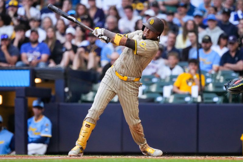 Jun 6, 2025; Milwaukee, Wisconsin, USA;  San Diego Padres designated hitter Luis Arraez (4) hits an RBI single during the third inning against the Milwaukee Brewers at American Family Field. Mandatory Credit: Jeff Hanisch-Imagn Images
