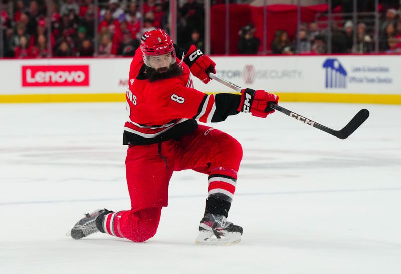 Nov 26, 2023; Raleigh, North Carolina, USA; Carolina Hurricanes defenseman Brent Burns (8) takes a shot against the Columbus Blue Jackets during the first period at PNC Arena. Mandatory Credit: James Guillory-USA TODAY Sports